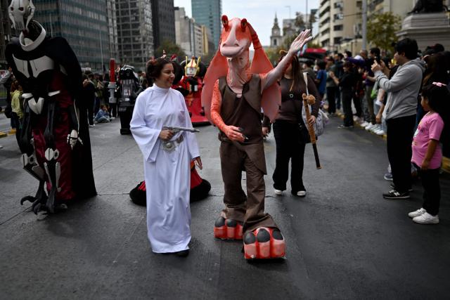 Fans wearing costumes from the Star Wars films take part in the Desfile de las Galaxias 2026 in Santiago on April 18, 2026. (Photo by RODRIGO ARANGUA / AFP)
