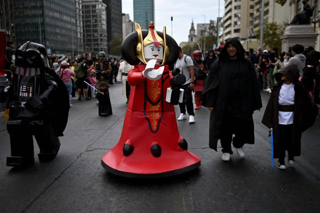 Fans wearing costumes from the Star Wars films take part in the Desfile de las Galaxias 2026 in Santiago on April 18, 2026. (Photo by RODRIGO ARANGUA / AFP)