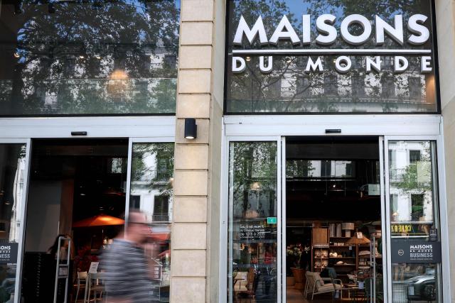 Pedestrians walk past a "Maisons du Monde" store in Paris on April 18, 2026. (Photo by ALAIN JOCARD / AFP)
