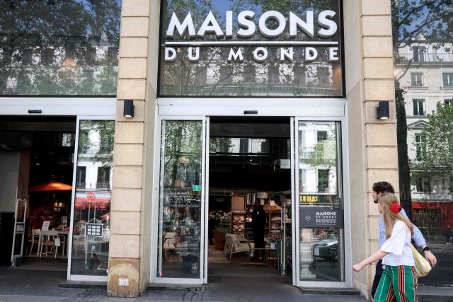 Pedestrians walk past a "Maisons du Monde" store in Paris on April 18, 2026. (Photo by ALAIN JOCARD / AFP)