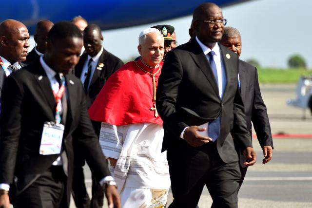 Pope Leo XIV (C) arrives at the "4 de Fevereiro" Luanda International Airport in Luanda on the sixth day of an 11-day apostolic journey to Africa, on April 18, 2026. (Photo by Julio PACHECO NTELA / AFP)