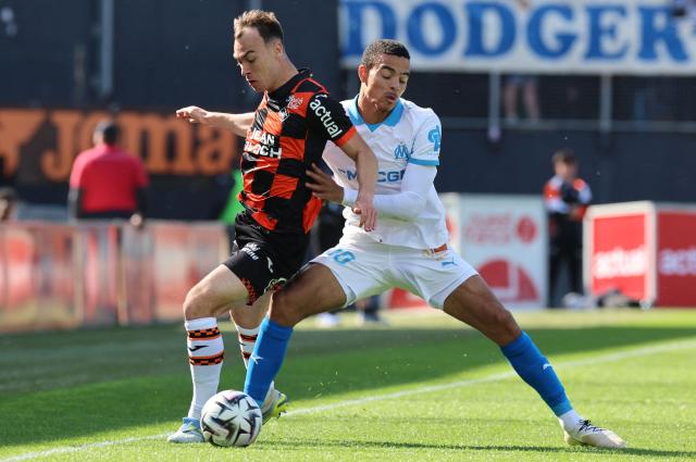 Lorient's French forward #10 Pablo Pagis (L) fights for the ball with Marseille's English forward #10 Mason Greenwood (R) during the French L1 football match between FC Lorient and Olympique de Marseille at the Moustoir stadium in Lorient, western France on April 18, 2026. (Photo by Fred TANNEAU / AFP)