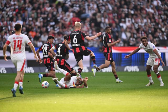 Leipzig's Norwegian forward #07 Antonio Nusa (4th L, bottom) reacts on the ground as Frankfurt's Moroccan forward #29 Ayoube Amaimouni-Echghouyab (2nd, L), Frankfurt's German defender #04 Robin Koch (3rd, L) and Frankfurt's Danish midfielder #06 Oscar Hojlund (5th L) vie during the German first division Bundesliga football match between Eintracht Frankfurt and RB Leipzig in Frankfurt am Main, western Germany, on April 18, 2026. (Photo by Kirill KUDRYAVTSEV / AFP) / DFL REGULATIONS PROHIBIT ANY USE OF PHOTOGRAPHS AS IMAGE SEQUENCES AND/OR QUASI-VIDEO