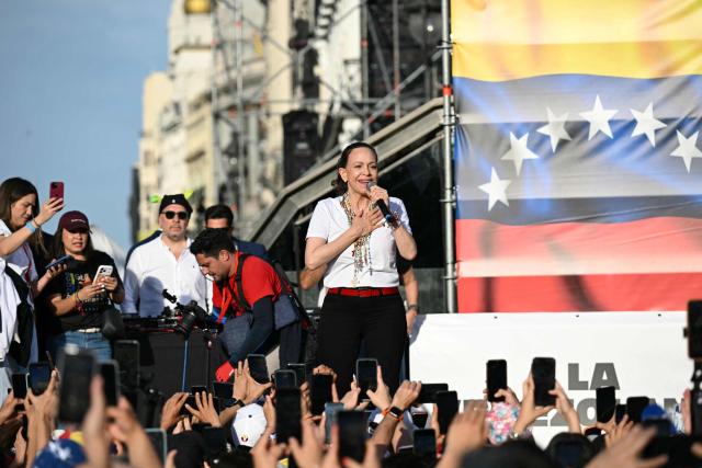 Venezuelan opposition leader Maria Corina Machado speaks to supporters on stage in Madrid's Puerta del Sol on April 18, 2026. Spain's right-wing parties showed their support for Venezuelan opposition figure and Nobel Peace Prize winner Maria Corina Machado who  turned down a meeting with the country's leftist PM, considering it 'unsuitable' for the moment. (Photo by Javier SORIANO / AFP)