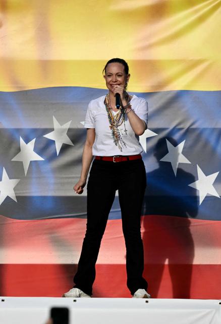 Venezuelan opposition leader Maria Corina Machado speaks to supporters on stage in Madrid's Puerta del Sol on April 18, 2026. Spain's right-wing parties showed their support for Venezuelan opposition figure and Nobel Peace Prize winner Maria Corina Machado who  turned down a meeting with the country's leftist PM, considering it 'unsuitable' for the moment. (Photo by Javier SORIANO / AFP)