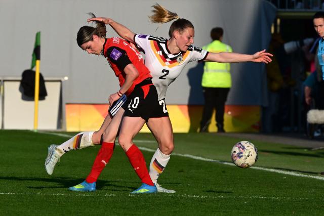 Austria's forward #10 Eileen Campbell (L) and Germany's defender #02 Sarai Linder vie for the ball during the Women's FIFA world cup league A, group A4, qualifier football match between Austria and Germany at Josko Arena in Ried, Austria, on April 18, 2026. (Photo by Reinhard EISENBAUER / APA / AFP) / Austria OUT