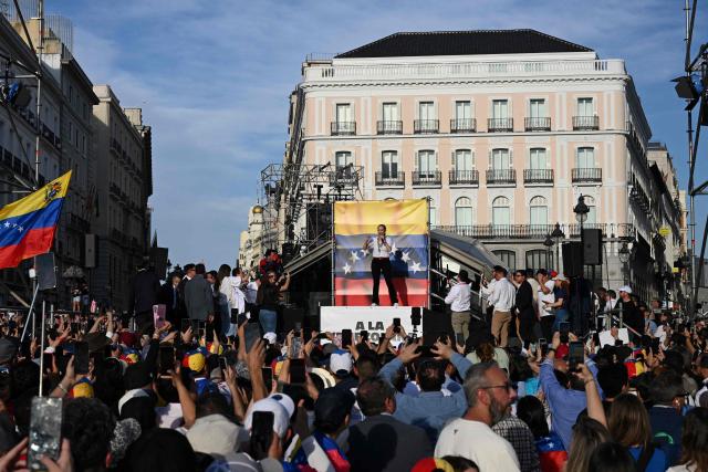 Venezuelan opposition leader Maria Corina Machado speaks to supporters on stage in Madrid's Puerta del Sol on April 18, 2026. Spain's right-wing parties showed their support for Venezuelan opposition figure and Nobel Peace Prize winner Maria Corina Machado who  turned down a meeting with the country's leftist PM, considering it 'unsuitable' for the moment. (Photo by JAVIER SORIANO / AFP)
