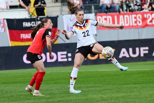 Austria's defender #02 Chiara D'Angelo and Germany's midfielder #22 Jule Brand vie for the ball during the Women's FIFA world cup league A, group A4, qualifier football match between Austria and Germany at Josko Arena in Ried, Austria, on April 18, 2026. (Photo by Reinhard EISENBAUER / APA / AFP) / Austria OUT