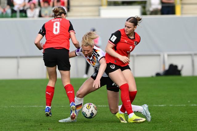 Austria's midfielder #08 Barbara Dunst (L) and Austria's defender #03 Sarah Gutmann vie for the ball with Germany's defender #02 Sarai Linder vie for the ball during the Women's FIFA world cup league A, group A4, qualifier football match between Austria and Germany at Josko Arena in Ried, Austria, on April 18, 2026. (Photo by Reinhard EISENBAUER / APA / AFP) / Austria OUT