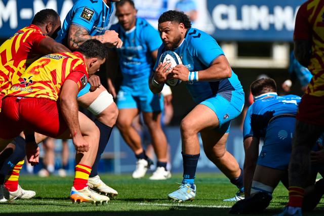 Montpellier's French prop Mohamed Haouas (R) runs with the ball during the French Top14 rugby union match between Montpellier Herault Rugby and USA Perpignan at the Septeo Stadium in Montpellier, southern France on April 18, 2026. (Photo by Sylvain THOMAS / AFP)