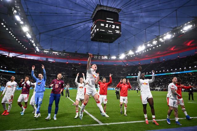 Leipzig's Danish forward #11 Conrad Harder (C) and team mates celebrate with fans after the end of the German first division Bundesliga football match between Eintracht Frankfurt and RB Leipzig in Frankfurt am Main, western Germany, on April 18, 2026. (Photo by Kirill KUDRYAVTSEV / AFP) / DFL REGULATIONS PROHIBIT ANY USE OF PHOTOGRAPHS AS IMAGE SEQUENCES AND/OR QUASI-VIDEO