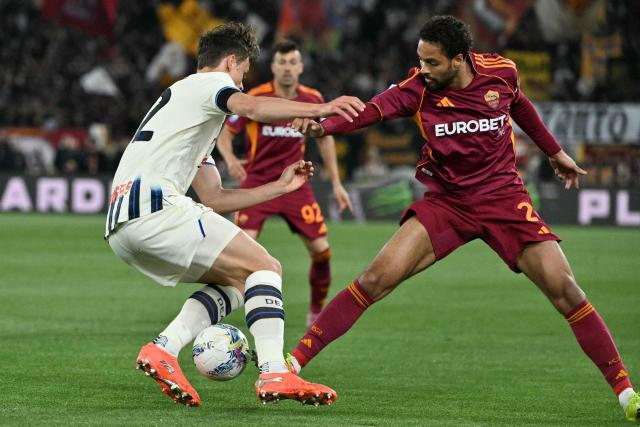 Roma's Dutch defender #02 Devyne Rensch fights for the ball with Atalanta's Italian defender #42 Giorgio Scalvini during the Italian Serie A football match between AS Roma and Atalanta at the Olympic Stadium in Rome on April 18, 2026. (Photo by Tiziana FABI / AFP)