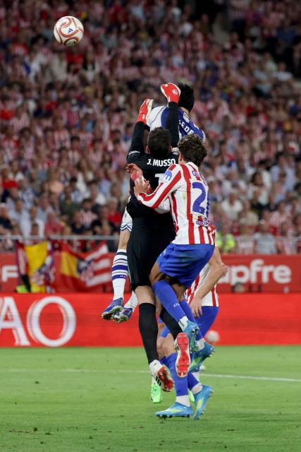 Atletico Madrid's Argentine goalkeeper #01 Juan Musso jumps for the ball during the Copa del Rey (King's Cup) final football match between Club Atletico de Madrid and Real Sociedad at La Cartuja stadium in Seville on April 18, 2026. (Photo by Thomas COEX / AFP)
