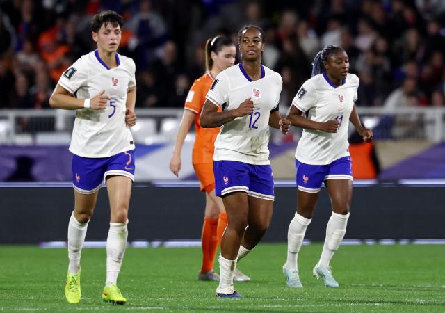 Frence's forward #12 Marie Antoinette Katoto (C) celebrates after scoring the opening goal during the women's FIFA world cup league A, group 2, qualifying football match between France and The Netherlands at the Stade de l'Abbe-Deschamps in Auxerre, central France on April 18, 2026. (Photo by FRANCK FIFE / AFP)