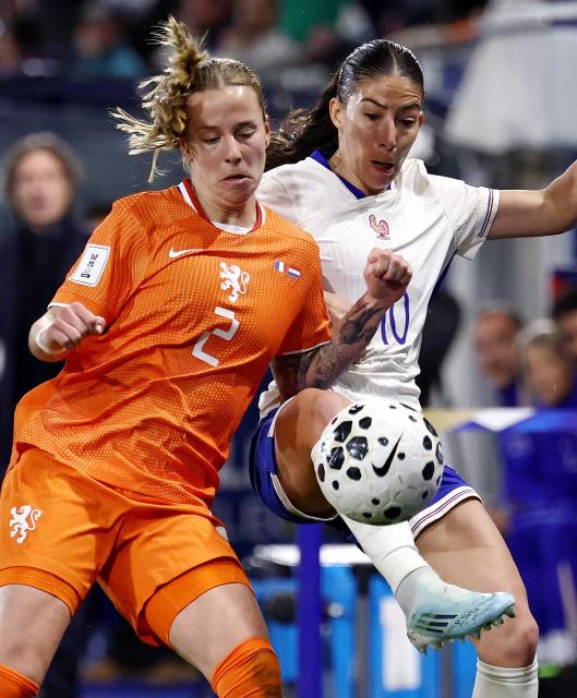 Netherlands' defender #02 Lynn Wilms (L) fights for the ball with France's midfielder #10 Clara Mateo during the women's FIFA world cup league A, group 2, qualifying football match between France and The Netherlands at the Stade de l'Abbe-Deschamps in Auxerre, central France on April 18, 2026. (Photo by FRANCK FIFE / AFP)