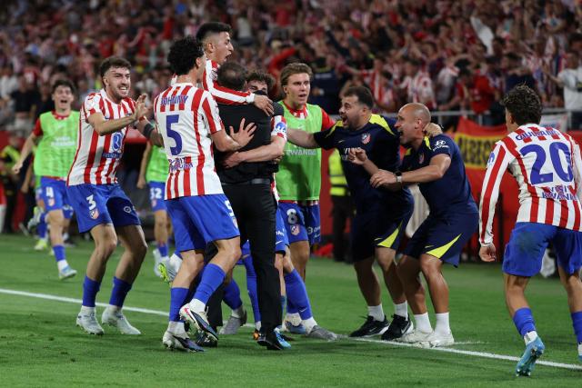 Atletico Madrid's Argentine forward #19 Julian Alvarez celebrates scoring his team's second goal with Atletico Madrid's Argentine coach Diego Simeone during the Copa del Rey (King's Cup) final football match between Club Atletico de Madrid and Real Sociedad at La Cartuja stadium in Seville on April 18, 2026. (Photo by Thomas COEX / AFP)