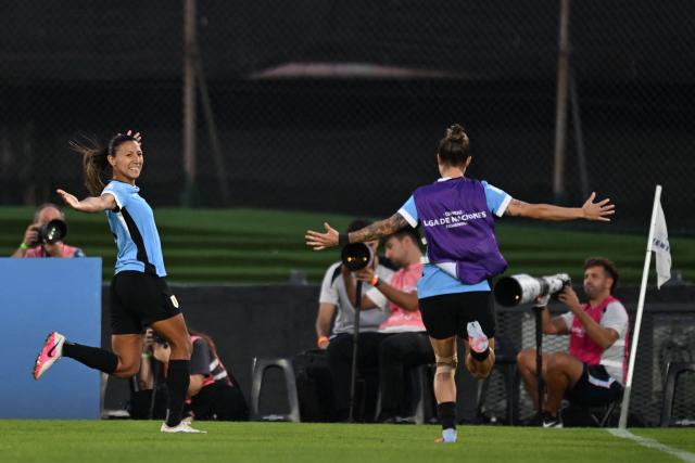 Uruguay's midfielder #09 Pamela Gonzalez (L) celebrates scoring her team's first goal during the CONMEBOL Nations League Women football match between Uruguay and Chile at the Centenario stadium in Montevideo, on April 18, 2026. (Photo by Eitan ABRAMOVICH / AFP)