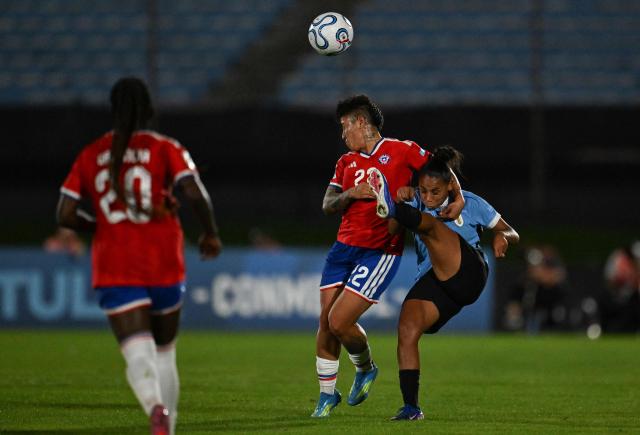 Chile's defender #22 Valentina Diaz and Uruguay's forward #19 Wendy Carballo fight for the ball during the CONMEBOL Nations League Women football match between Uruguay and Chile at the Centenario stadium in Montevideo, on April 18, 2026. (Photo by Eitan ABRAMOVICH / AFP)