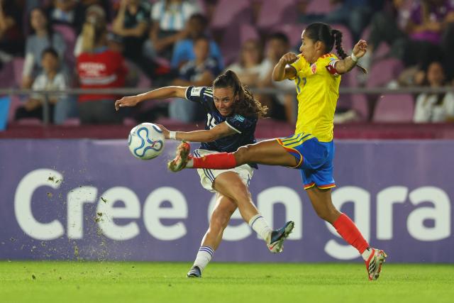Argentina's defender #15 Maria Bonsegundo kicks the ball past Colombia's defender #17 Carolina Arias during the CONMEBOL Nations League Women football match between Argentina and Colombia, at the Ciudad de Lanus stadium in Lanus, Buenos Aires province, Argentina, on April 18, 2026. (Photo by Alejandro PAGNI / AFP)