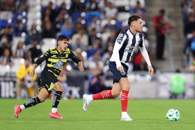 Monterrey's Argentine midfielder #29 Lucas Ocampos (R) runs with the ball past Pachuca's defender #14 Carlos Sanchez (L) during the Liga MX Clausura football match between Monterrey and Pachuca at BBVA stadium in Guadalupe, Nuevo Leon state, Mexico on April 18, 2026. (Photo by Julio Cesar AGUILAR / AFP)