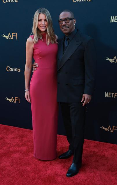 US actor Eddie Murphy and his wife Australian actress Paige Butcher attend the 2026 AFI Life Achievement Award at the Dolby Theatre in Hollywood, California on April 18, 2026. US actor Eddie Murphy is the recipient of the 2026 AFI Life Achievement Award. (Photo by Etienne LAURENT / AFP)