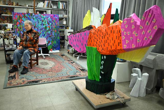 This picture taken on March 4, 2026, shows South Korean sculptor Kim Yun Shin speaking during an interview with AFP at her studio in Paju. In her 90s, South Korean sculptor Kim Yun Shin still wields a chainsaw with quiet focus, refining a craft she honed over decades spent far away from home. (Photo by Jung Yeon-je / AFP) / TO GO WITH AFP STORY  SKorea-Art BY Claire LEE