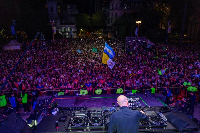 This aerial view shows Portuguese priest and DJ Padre Guilherme performing during a free electronic music event in Plaza de Mayo, Buenos Aires on April 18, 2026, held in tribute to Pope Francis on the first anniversary of his death. (Photo by Tomas CUESTA / AFP)