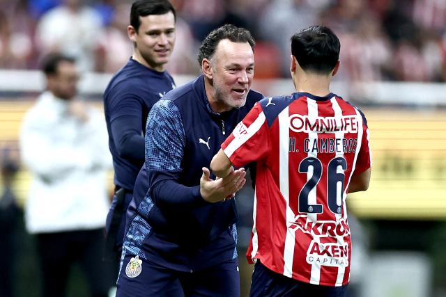 Guadalajara's forward #26 Hugo Camberos celebrates scoring his team's fifth goal with Argentine head coach Gabriel Milito during the Liga MX Clausura football match between Guadalajara and Puebla at Akron stadium in Zapopan, Jalisco state, Mexico on April 18, 2026. (Photo by ULISES RUIZ / AFP)