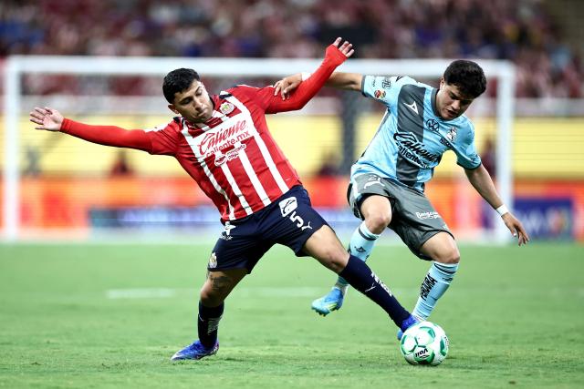Guadalajara's defender #05 Bryan Gonzalez (L) and Puebla's midfielder #21 Owen Gonzalez (R) fight for the ball during the Liga MX Clausura football match between Guadalajara and Puebla at Akron stadium in Zapopan, Jalisco state, Mexico on April 18, 2026. (Photo by Ulises Ruiz / AFP)