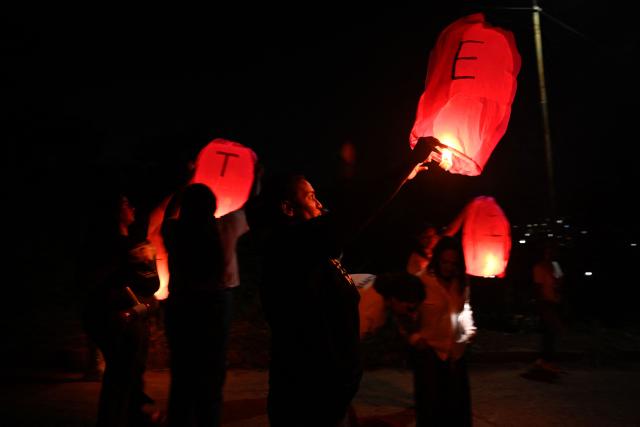 Relatives of Venezuelan political prisoners light sky lanterns during a vigil marking 100 days since they began calling for their release outside El Rodeo I prison in Guatire, Miranda state, Venezuela on April 18, 2026. Under pressure from Washington, Venezuela's interim president Delcy Rodriguez pushed through an amnesty law that provided for the release of hundreds of political prisoners. The amnesty came into force on February 19, 2026, but it is not automatic, as it requires the benefit to be applied for through the courts. (Photo by Maryorin Mendez / AFP)