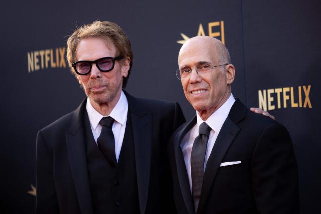 US film producers Jerry Bruckheimer (L) and Jeffrey Katzenberg (R) attend the 2026 AFI Life Achievement Award at the Dolby Theatre in Hollywood, California on April 18, 2026. US actor Eddie Murphy is the recipient of the 2026 AFI Life Achievement Award. (Photo by ETIENNE LAURENT / AFP)