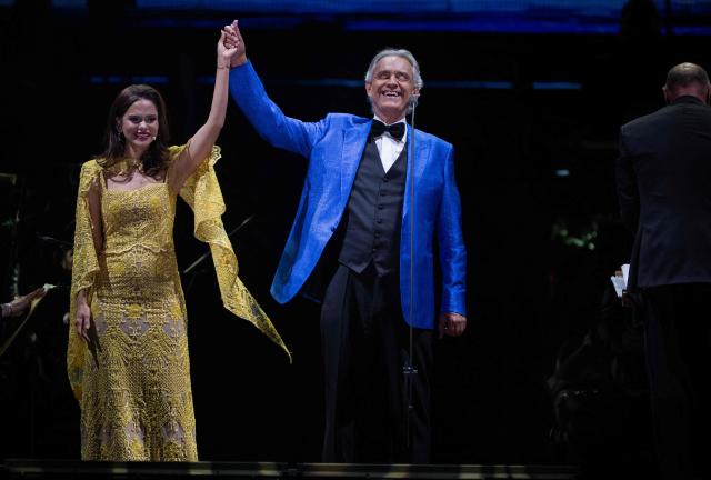 Italian tenor classical musician Andrea Bocelli (R) and Puerto Rican soprano Larisa Martinez (L) perform on stage during a free concert at the Zocalo square in Mexico City on April 18, 2026. (Photo by Carl DE SOUZA / AFP)