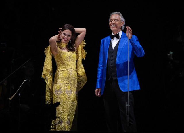Italian tenor classical musician Andrea Bocelli (R) and Puerto Rican soprano Larisa Martinez (L) perform on stage during a free concert at the Zocalo square in Mexico City on April 18, 2026. (Photo by Carl DE SOUZA / AFP)