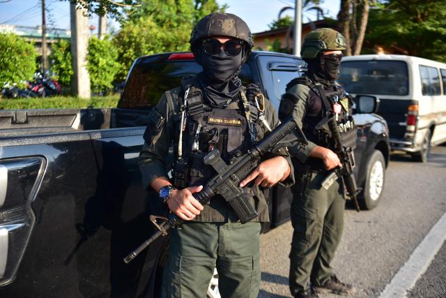 Thai police officers stand guard as muslims gather to offer prayers a few weeks after an attack tageting Kamolsak Leewamoh, a member of parliament from the Prachachat Party, in the southern Thai province of Narathiwat on April 19, 2026. (Photo by Madaree TOHLALA / AFP)