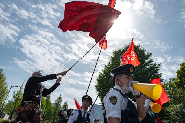 People take part in a "No war! Don’t change the Constitution!" rally outside the main gate of the National Diet Building, to call for the protection of Article 9 of the Constitution of Japan, in Tokyo on April 19, 2026. Article 9 is a clause stipulating that the Japanese people have renounced war as a sovereign right of the nation and the threat or use of force as means of settling international disputes (Photo by Philip FONG / AFP)