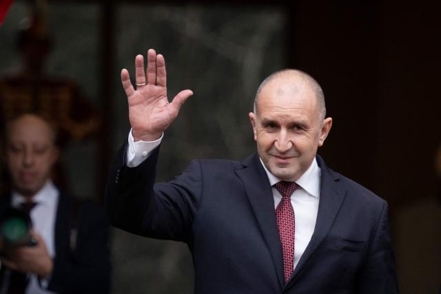 (FILES) Outgoing Bulgaria's President Rumen Radev gestures to suporters as he walks out from the Bulgarian Presidency parade entrance with the incoming President and former Vice President Iliana Iotova (not in the picture) in Sofia on January 23, 2026. The 62-year-old former fighter pilot, who presents himself as a defender of the most disadvantaged, appears in the eyes of many voters as the providential figure capable of offering Bulgaria a fresh start. (Photo by Nikolay DOYCHINOV / AFP)