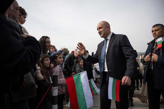 (FILES) Former Bulgaria's President Rumen Radev (C) greets his suporters during a ceremony marking Bulgaria’s Liberation Day at the Defenders of Stara Zagora Memorial Complex in Stara Zagora on March 3, 2026. The 62-year-old former fighter pilot, who presents himself as a defender of the most disadvantaged, appears in the eyes of many voters as the providential figure capable of offering Bulgaria a fresh start. (Photo by Nikolay DOYCHINOV / AFP)