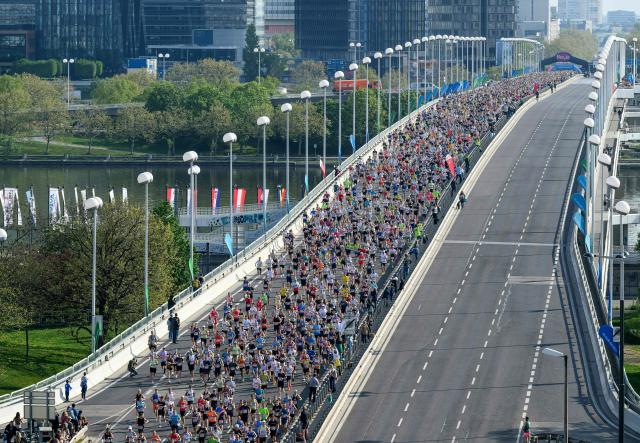 Runners take part in the Vienna City Marathon, crossing the Danube River via the Reichsbrücke bridge in Vienna on April 19, 2026. (Photo by MAX SLOVENCIK / APA / AFP) / Austria OUT