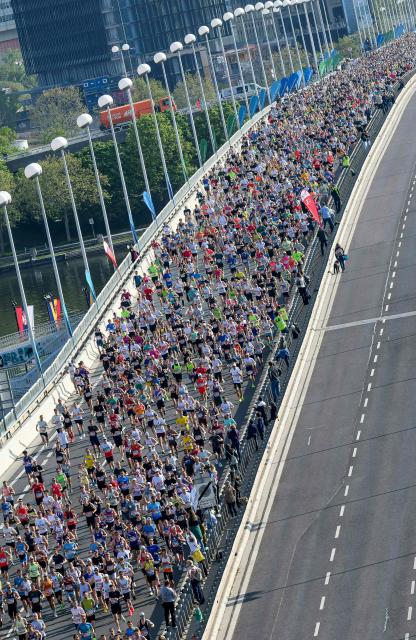 Runners take part in the Vienna City Marathon, crossing the Danube River via the Reichsbrücke bridge in Vienna on April 19, 2026. (Photo by MAX SLOVENCIK / APA / AFP) / Austria OUT