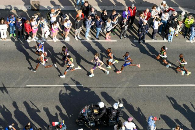 Runners take part in the Vienna City Marathon, crossing the Danube River via the Reichsbrücke bridge in Vienna on April 19, 2026. (Photo by MAX SLOVENCIK / APA / AFP) / Austria OUT