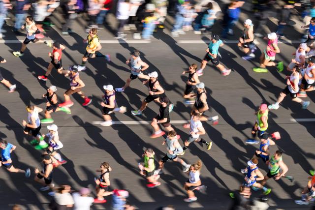 Runners take part in the Vienna City Marathon, crossing the Danube River via the Reichsbrücke bridge in Vienna on April 19, 2026. (Photo by MAX SLOVENCIK / APA / AFP) / Austria OUT