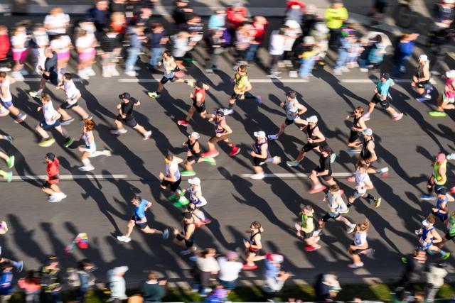 Runners take part in the Vienna City Marathon, crossing the Danube River via the Reichsbrücke bridge in Vienna on April 19, 2026. (Photo by MAX SLOVENCIK / APA / AFP) / Austria OUT