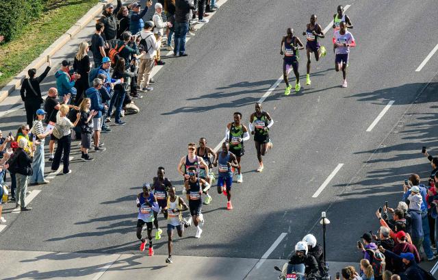Runners take part in the Vienna City Marathon, crossing the Danube River via the Reichsbrücke bridge in Vienna on April 19, 2026. (Photo by MAX SLOVENCIK / APA / AFP) / Austria OUT
