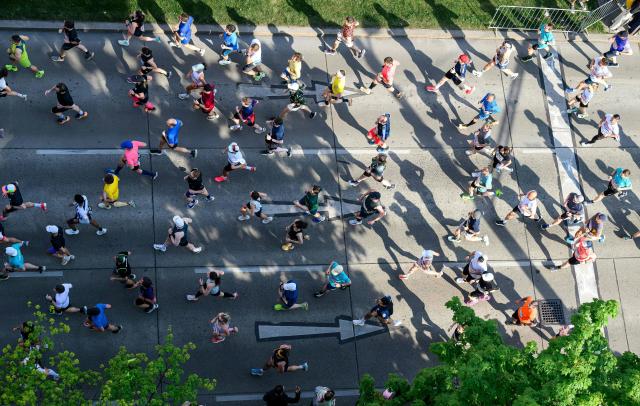 Runners take part in the Vienna City Marathon, crossing the Danube River via the Reichsbrücke bridge in Vienna on April 19, 2026. (Photo by MAX SLOVENCIK / APA / AFP) / Austria OUT