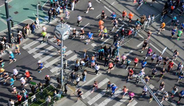 Runners take part in the Vienna City Marathon, crossing the Danube River via the Reichsbrücke bridge in Vienna on April 19, 2026. (Photo by MAX SLOVENCIK / APA / AFP) / Austria OUT