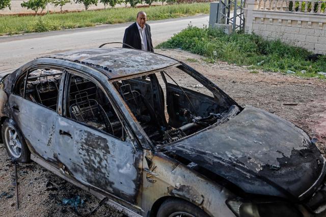 A Palestinian man inspects a burnt car following a reported attack by Israeli settlers in Turmus Ayya village, north of Ramallah in the Israeli-occupied West Bank on April 19, 2026. Violence in the West Bank, which Israel has occupied since 1967, has risen sharply since the October 7, 2023 Hamas attack on Israel triggered the Gaza war. There has also been a spike in deadly attacks by Israeli settlers in the West Bank since the start of the Iran war on February 28, Palestinian authorities and the United Nations have said. (Photo by Zain JAAFAR / AFP)