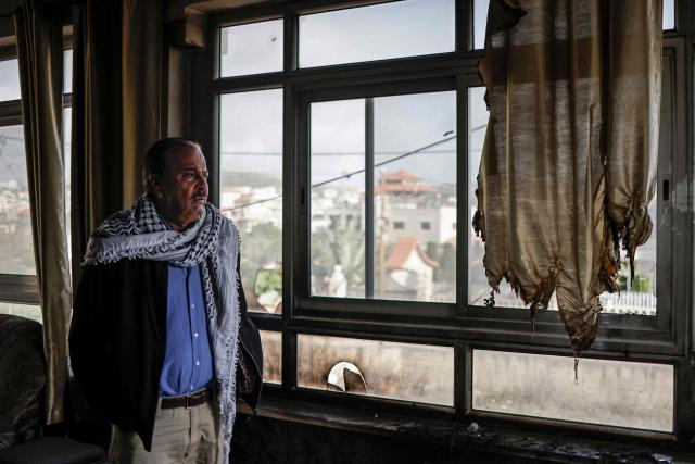 A Palestinian man stands inside a burnt house following a reported attack by Israeli settlers in Turmus Ayya village, north of Ramallah in the Israeli-occupied West Bank on April 19, 2026. Violence in the West Bank, which Israel has occupied since 1967, has risen sharply since the October 7, 2023 Hamas attack on Israel triggered the Gaza war. There has also been a spike in deadly attacks by Israeli settlers in the West Bank since the start of the Iran war on February 28, Palestinian authorities and the United Nations have said. (Photo by Zain JAAFAR / AFP)