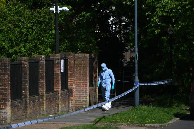 A police forensic officer works inside a cordon set up near to Kenton United Synagogue in Harrow, north-west London on April 19, 2026, the scene of an arson attack overnight. (Photo by JUSTIN TALLIS / AFP)