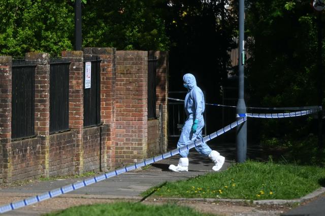A police forensic officer works inside a cordon set up near to Kenton United Synagogue in Harrow, north-west London on April 19, 2026, the scene of an arson attack overnight. (Photo by JUSTIN TALLIS / AFP)
