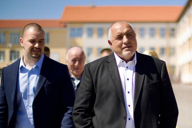 Leader of the GERB party and former Prime minister Boyko Borisov (R) walks away after casting his ballot at a polling station during Bulgaria's parliamentary elections in Sofia on April 19, 2026. Bulgarians vote in the country's eighth election in five years today, with ex-president Rumen Radev's grouping tipped to win on a pledge to fight corruption, after an anti-graft movement triggered a long political crisis. (Photo by DIMITAR KYOSEMARLIEV / AFP)